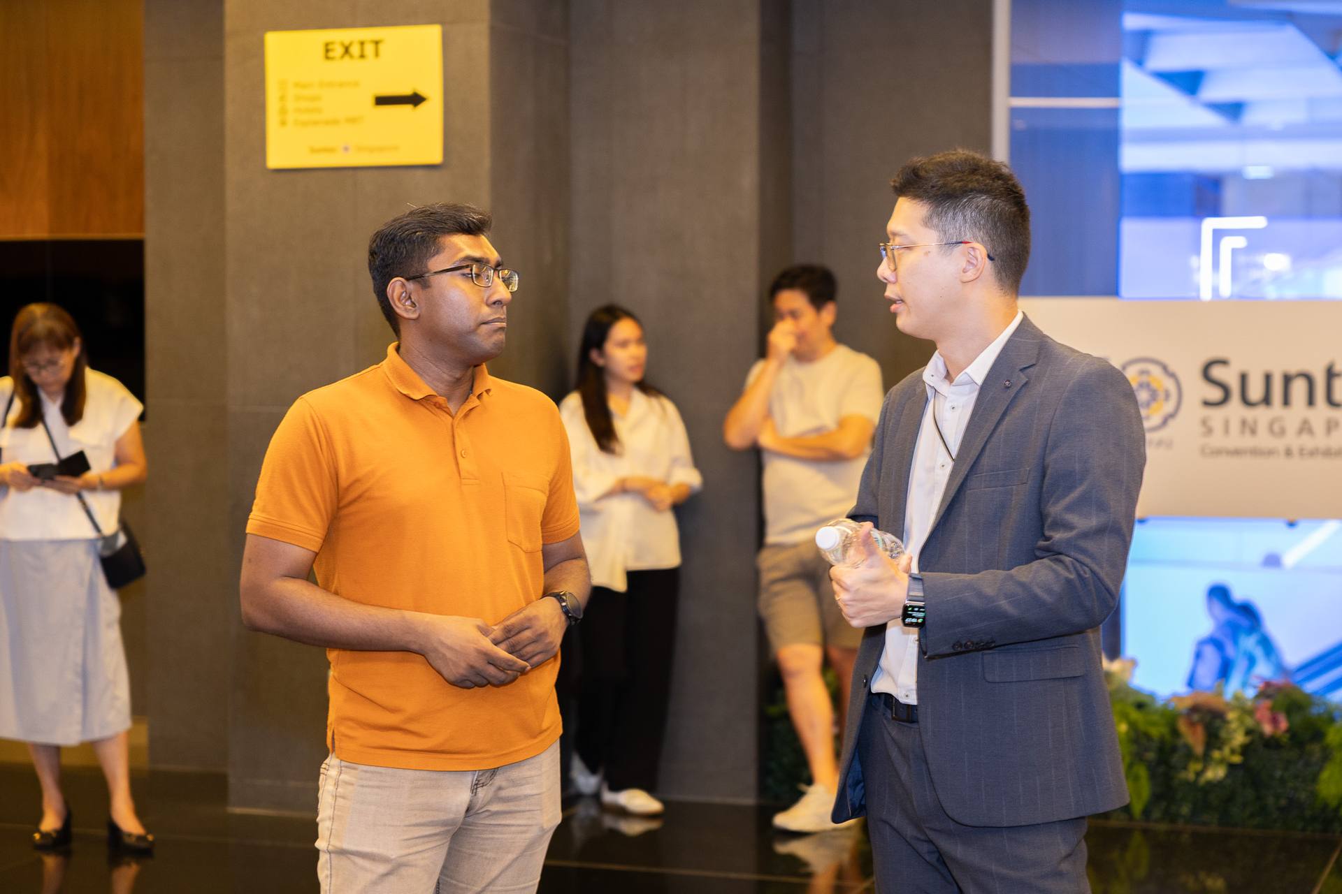 A Crestbrick associate in conversation with a guest at an event