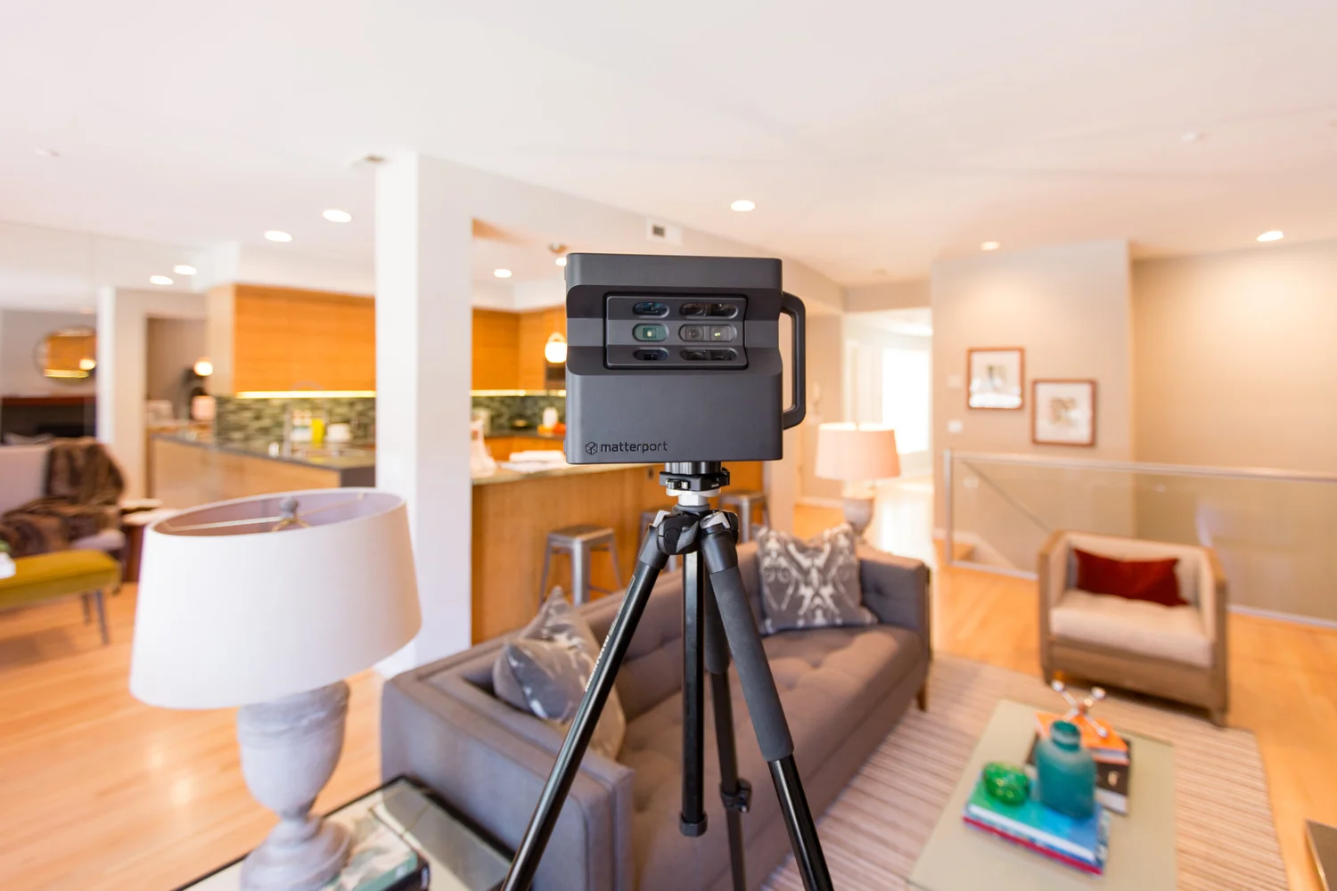A Matterport 3D camera scanning a staged living space