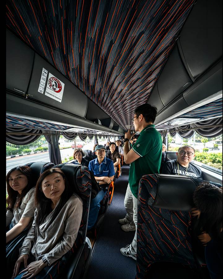 A Crestbrick associate briefing clients on the coach between Kuala Lumpur site visits