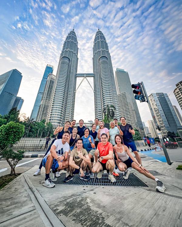 A Crestbrick tour group in Kuala Lumpur, with the Petronas Towers behind them