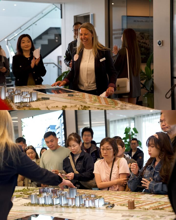 Clients viewing a scale model of a UK development in the sales gallery