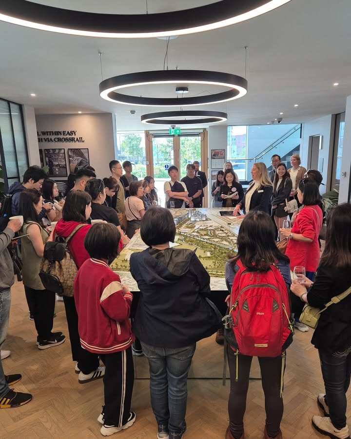 Crestbrick clients gathered around a scale model during a UK development briefing